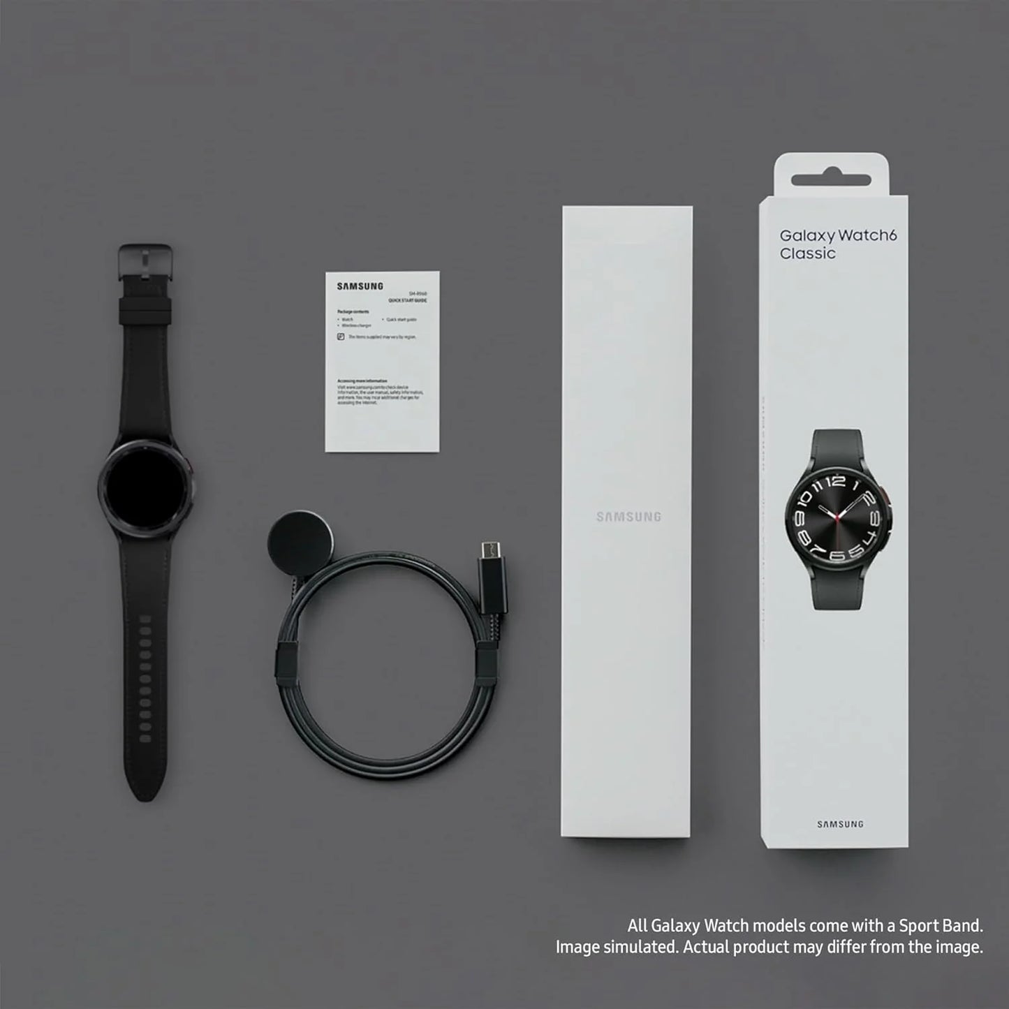Samsung Galaxy Watch Classic with packaging, strap, and cable on a gray background