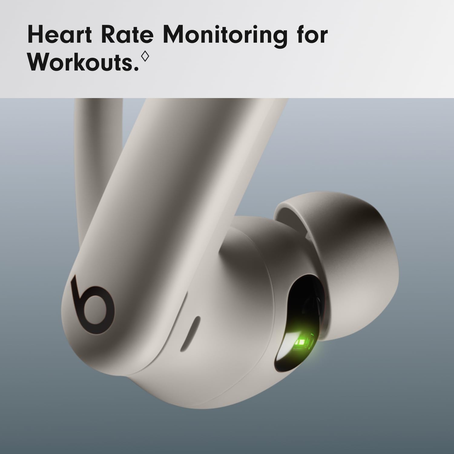 Beats wireless earbuds with heart rate monitoring feature on a gray background