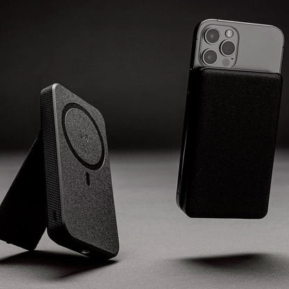 Black phone case with magnetic attachment feature on a dark background