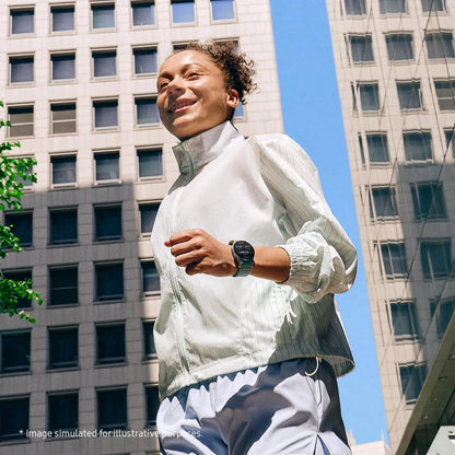 Woman in athletic wear standing in an urban setting with tall buildings.
