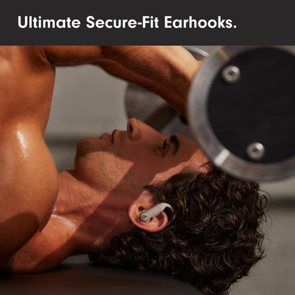 Person lifting weights with earphones on, text 'Ultimate Secure-Fit Earhooks'.