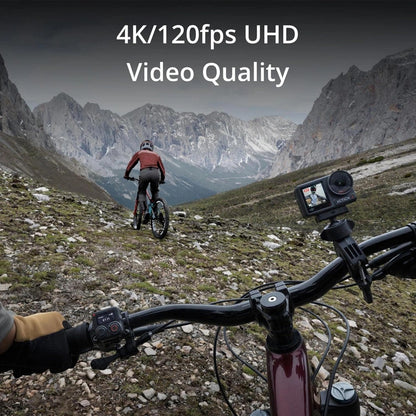 Biker on a mountain trail with a camera on the bike, showcasing 4K/120fps UHD video quality.