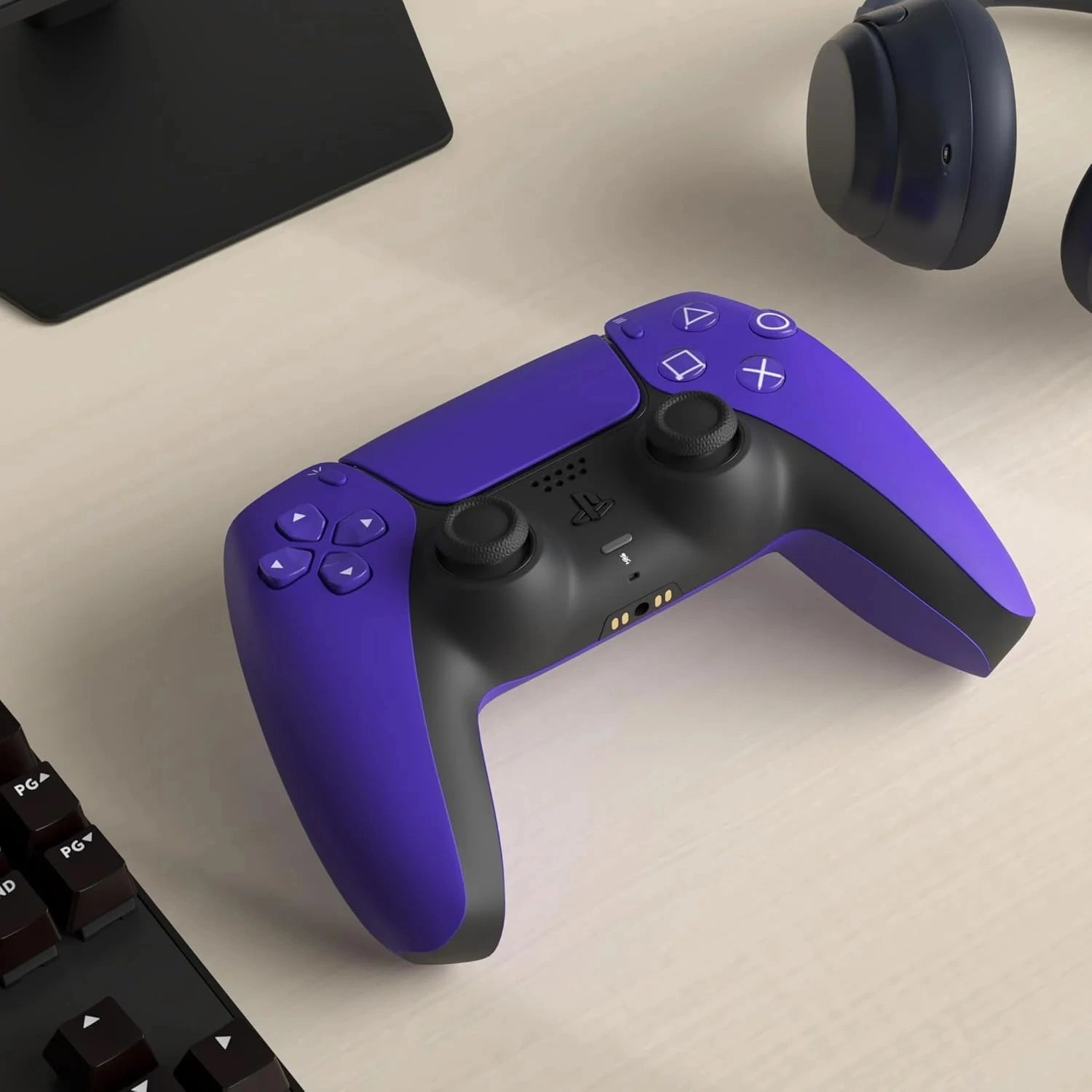 Purple gaming controller on a desk with a keyboard and mouse in the background