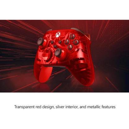 Red gaming controller with transparent design and silver interior on a dark background