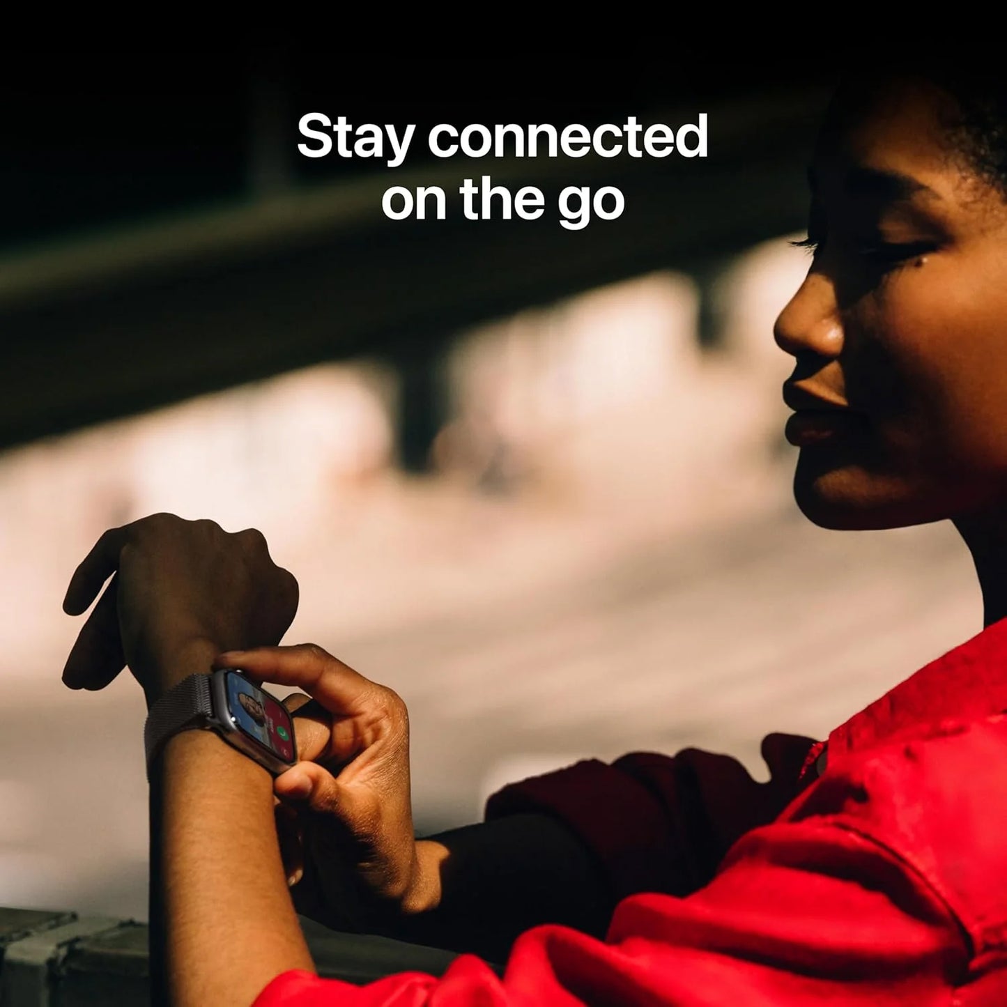 Person wearing a smartwatch with text 'Stay connected on the go' in an urban setting.