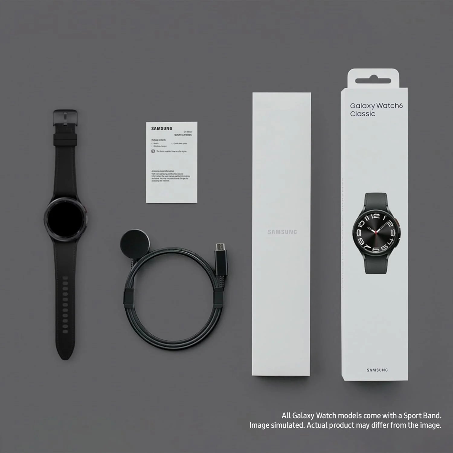 Samsung Galaxy Watch Classic with packaging, strap, and cable on a gray background