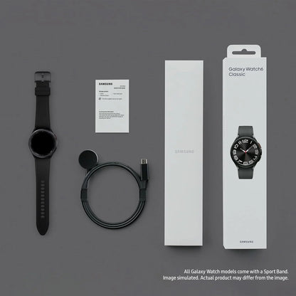 Samsung Galaxy Watch Classic with packaging, strap, and cable on a gray background